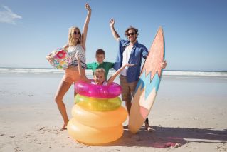 A family surrounded by fun beach toys